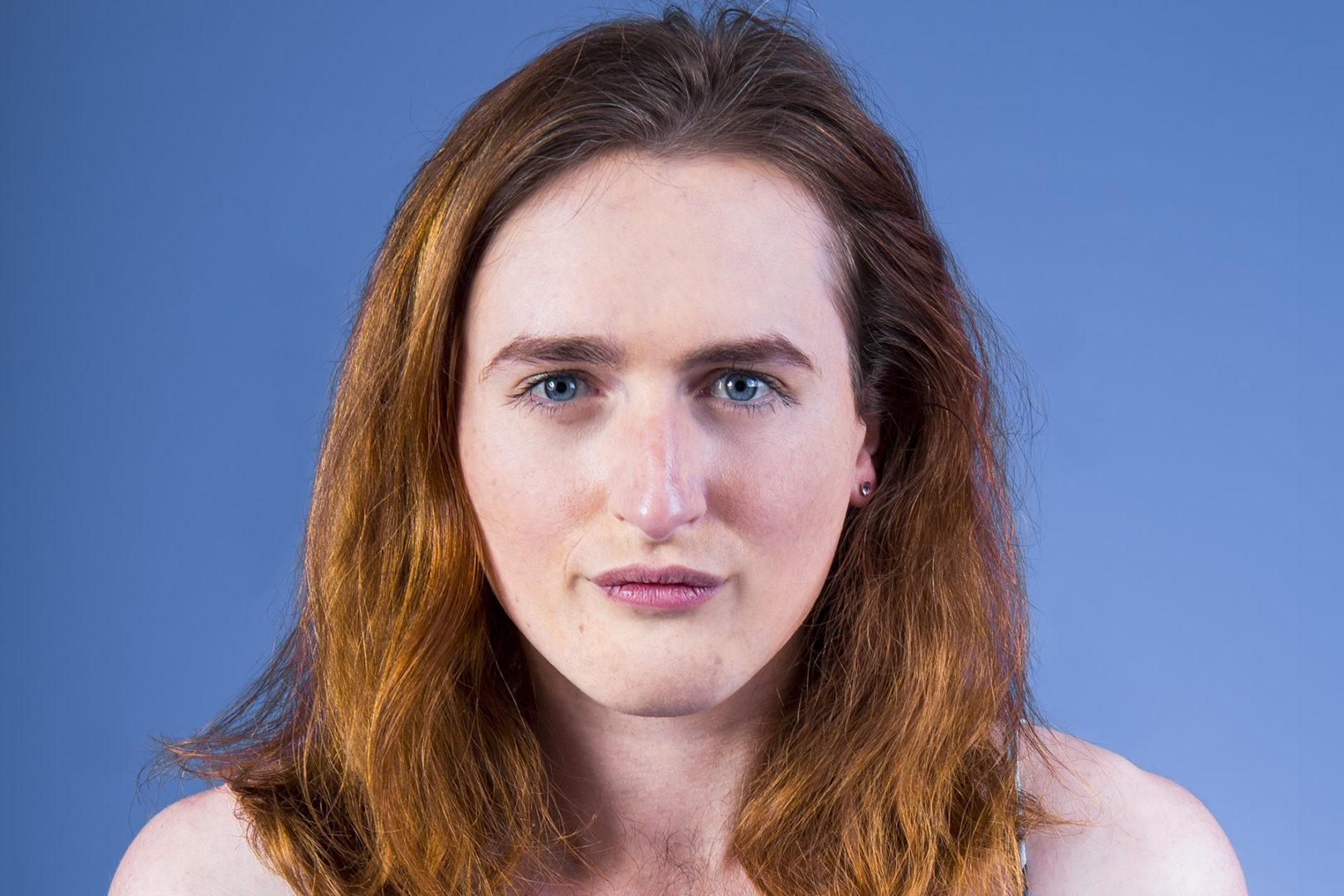 a portrait of a person with a blue background